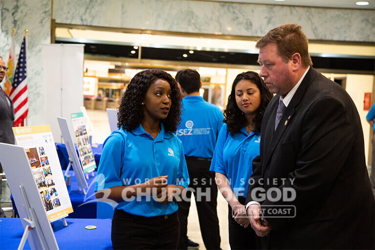 ASEZ volunteer explaining ASEZ's volunteer work to Assemblyman Chris Tague