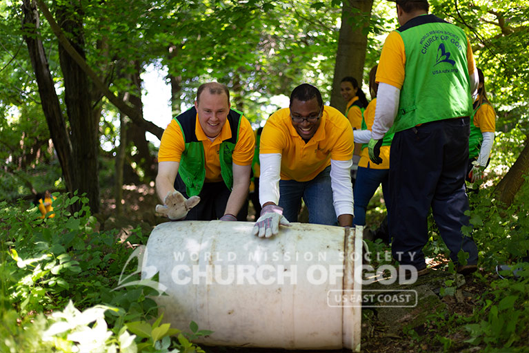 ASEZ WAO volunteers rolling an abandoned container from Haverstraw Beach State Park.