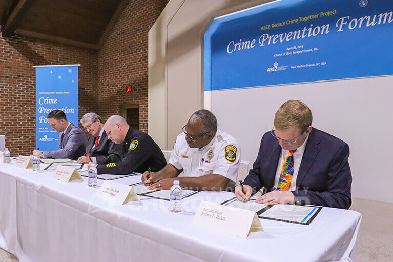 Police Chief Steve Drew, Sheriff Gabe Morgan, Professor Daniel Warman, and attorney Jeffrey Riddle signing to support ASEZ.