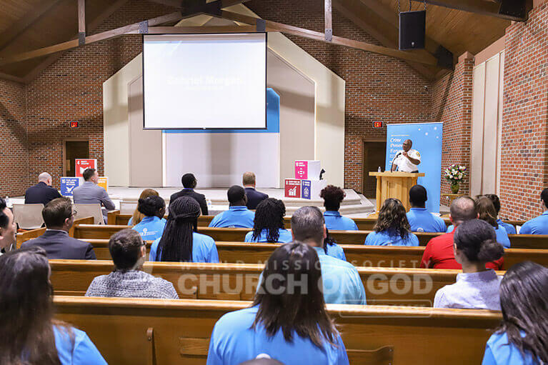 ASEZ volunteers and guests listen to Sherrif Gabe Morgan speak at the Crime Reduction Forum.