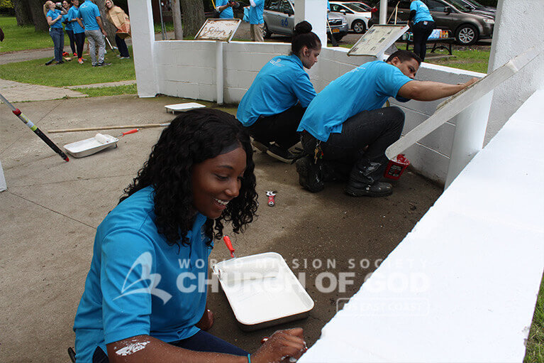 ASEZ student volunteers giving the gazebo at Prospect Park a new paint job