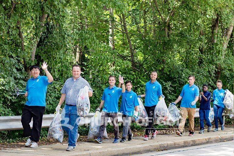 ASEZ volunteers in single file while removing trash from Mt. Pleasant Park.